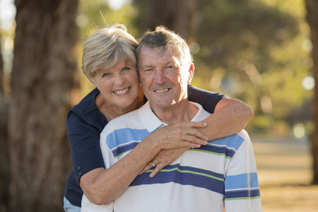 portrait of American senior beautiful and happy mature couple around 70 years old showing love and...