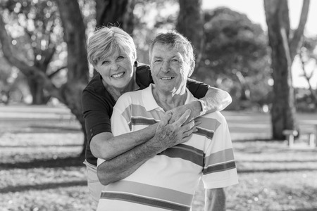 black and white portrait of American senior beautiful and happy mature couple around 70 years old...