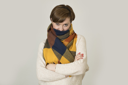 young beautiful and stylish 30s red hair woman sweater and Autumn colorful scarf smiling happy posing isolated on even background in seasonal fashion concept の写真素材