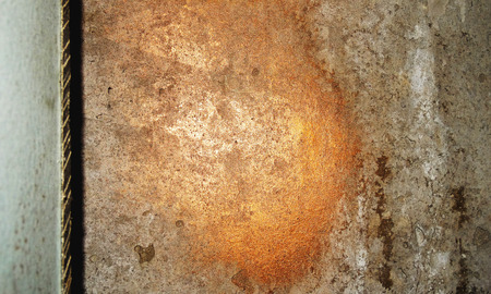 Copper and gold paint stains on old grunge wallの写真素材