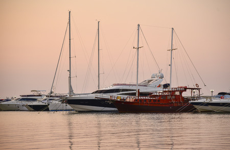 Pink sunset on the sea lights yachts sunshine silence boatの写真素材