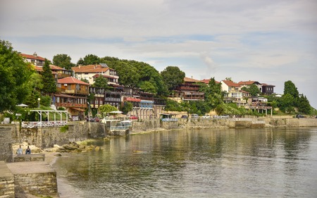 View of the seaside promenade with small cozy houses and water Bulgaria old Nessebarの写真素材