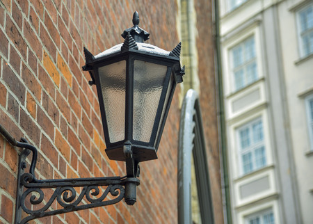 Vintage metal black lantern on the brick wall of the house street lampの写真素材