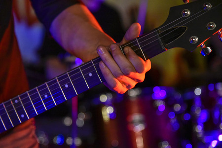 The neck of the guitar hand guitar player during the game , performer, jazz, bass, black, acoustic, handsの写真素材