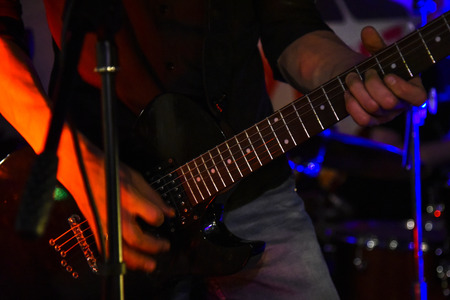 The neck of the guitar hand guitar player during the game , performer, jazz, bass, black, acoustic, handsの写真素材