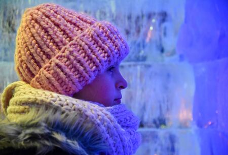 Girl winter night on the street in profile blue purple yellowの写真素材