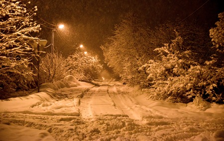 Winter landscape road in the forest night a lot of snow parkの写真素材