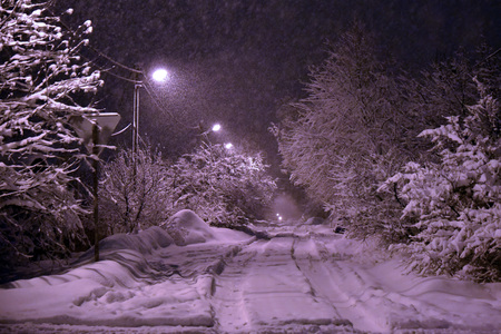 Winter landscape road in the forest night a lot of snow parkの写真素材
