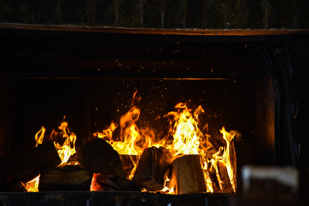 The flames of the fire in the fireplace winter black redの写真素材