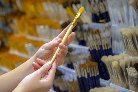 Painting brush art in the hands of the sale showcase yellow natural sinteticの写真素材