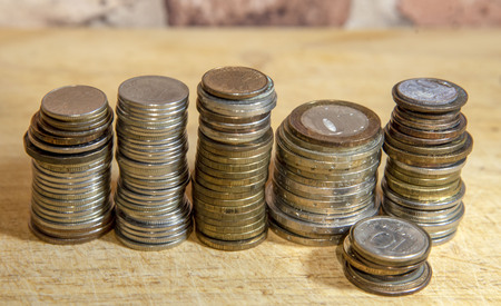 Stacks of coins and a vintage brick wall