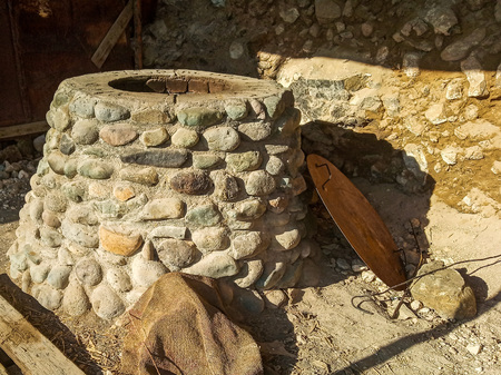 Stone Tandoor - oven-brazier, grill special spherical or pitcher type for cooking a variety of food among the peoples of Asiaの写真素材