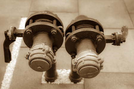 Fire hydrant a device on the water supply network that allows you to connect the equipment that provides water supply to extinguish the fire. Tinted photo.の写真素材