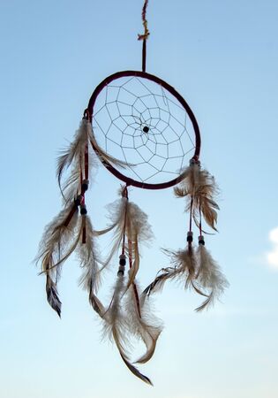 A Dreamcatcher suspended against a blue sky. Magic talisman.の写真素材