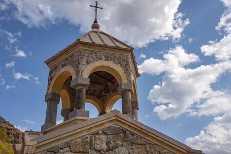 Armenian Church with bell tower on the background of bright blue cloudy sky.の写真素材