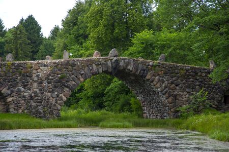 A bridge built of huge stones without bonding mortar over a pond in the Park.
