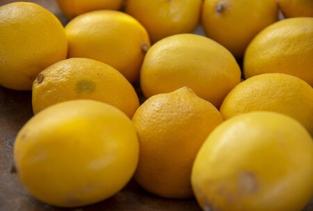 Lemon background.Selective focus.Bright yellow fruits are stacked side by side.の写真素材