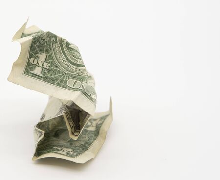 One old crumpled dollar on a light gray background.