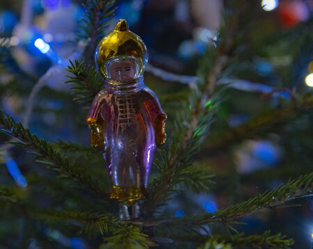 Vintage glass Soviet Christmas toy boy in a spaceman's suit hanging on the Christmas tree.の写真素材
