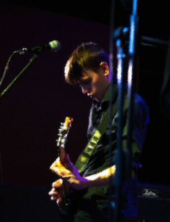 A young man playing the guitar. The illustration is based on my own photo.の写真素材