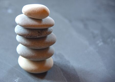A pyramid of sea stones on a tabletop.