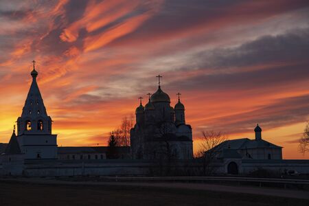 The black silhouette of the monastery against the bright sunset sky. Evening fascinating fantastic landscape.の写真素材