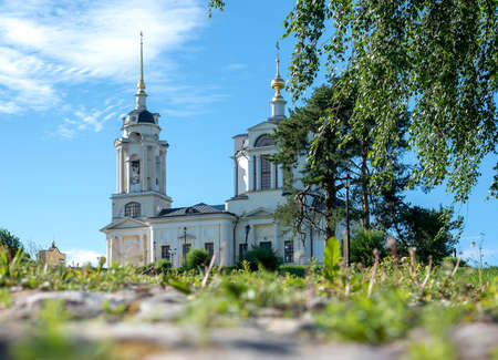 A beautiful Church with Golden domes is photographed from below. In the foreground, a road covered with paving stones and tree branches.の写真素材