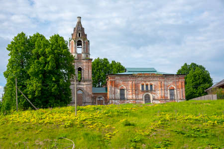 An old brick dilapidated Church on a green hill .の写真素材