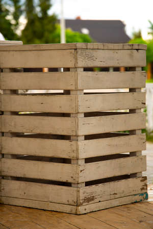 A box made of boards with peeling paint. The box was photographed from the corner.の写真素材