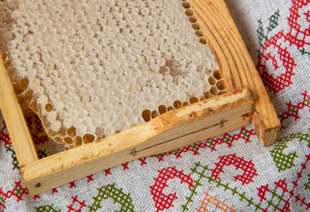 Fresh honeycombs lie on the linen tablecloth. Photographed from above, the concept of healthy eating.の写真素材
