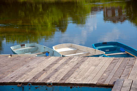 Wooden rowing boats on the water at the boat station.の写真素材