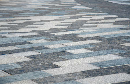 Full frame gray street tile as backdrop. Abstract background for design, copy space for text.