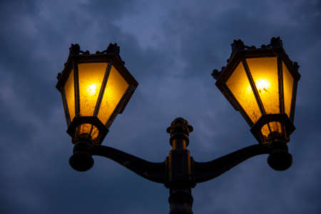A bright yellow lantern against a dark sky. Background for Halloween. Copy space for text.の写真素材