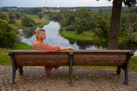 Portrait of a 65-year-old woman against the background of nature.の写真素材