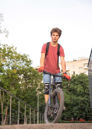 Russia, Moscow, September 2020. A seventeen-year-old boy rides a Bicycle in a public Park.のeditorial素材