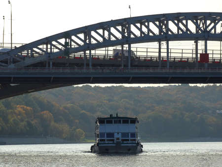 Russia, Moscow, September 2020. The ship sails on the Moscow river under the automobile bridge.のeditorial素材