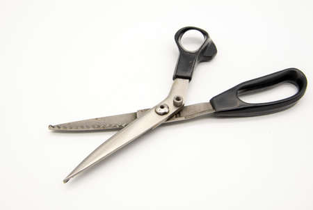Old metal tailor scissors on a white background.