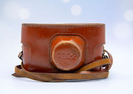 Russia, Tuchkovo Village, November 2020. Vintage camera in a leather case on a blue background.のeditorial素材