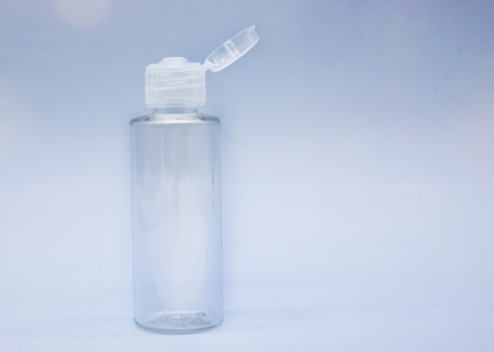 Transparent empty cosmetic bottles and jars on a soft blue background.の写真素材