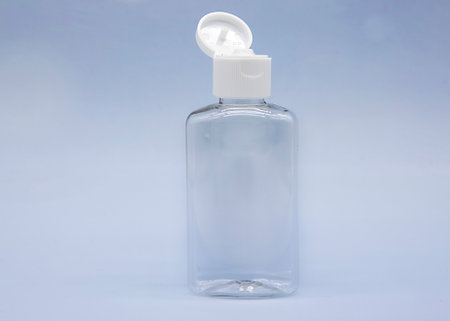 Transparent empty cosmetic bottles and jars on a soft blue background.の写真素材