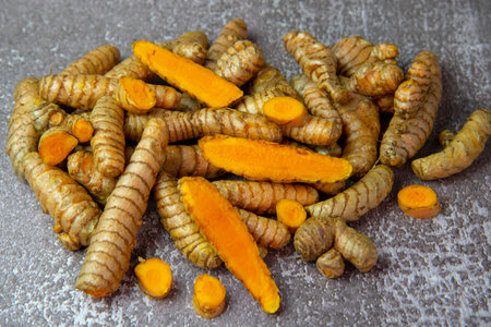 Fresh turmeric root on gray slate background. Food supplements, healthy eating.の写真素材