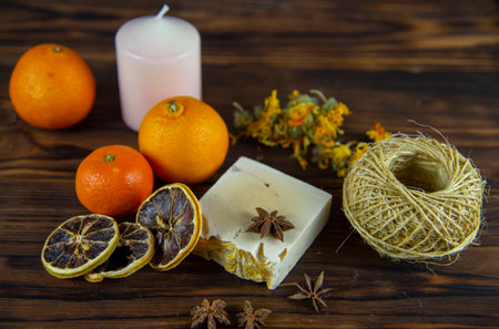 Natural handmade skincare. Handmade natural soap, candles and flowers on the dark wooden countertop.の写真素材