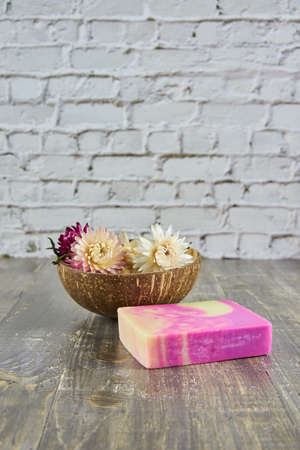 Organic scented handmade soap on a wooden gray countertop surrounded by decor. The concept of a healthy lifestyle.の写真素材