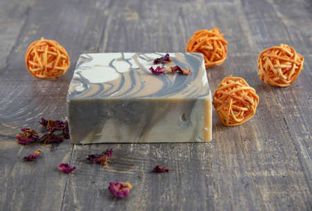 Organic scented handmade soap on a wooden gray countertop surrounded by decor. The concept of a healthy lifestyle.の写真素材