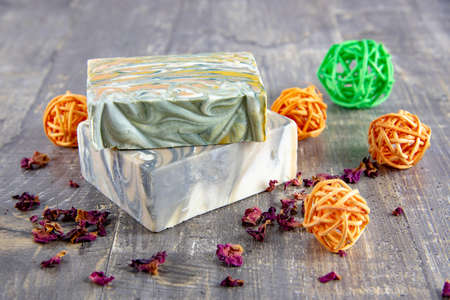 Organic scented handmade soap on a wooden gray countertop surrounded by decor. The concept of a healthy lifestyle.の写真素材