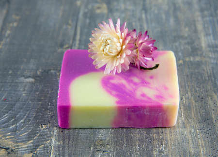 A piece of fragrant handmade soap lies on the gray countertop. The concept of a healthy lifestyle. Spa products.の写真素材