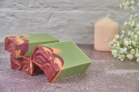 Bright, fragrant handmade soap and delicate gypsophila flowers on the gray countertop. Copy space for text, design.の写真素材