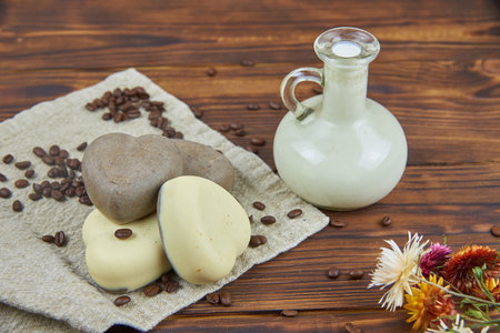Handmade soap in the shape of a heart with coffee and milk additives. Healthy lifestyle.の写真素材