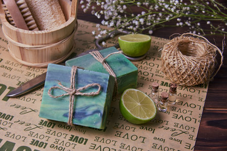 Fragrant handmade soap, scissors and rope, lemon and lime, lie on the packaging paper with the inscription love. Healthy lifestyle, online sales.の写真素材