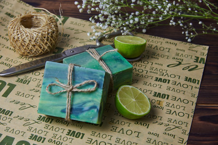 Fragrant handmade soap, scissors and rope, lemon and lime, lie on the packaging paper with the inscription love. Healthy lifestyle, online sales.の写真素材